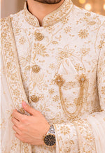 Off white Sherwani with complete jardozi handwork from top to bottom to enrich the groom’s attire on the wedding night with saafa and dupatta wrapped in the most stylish manner with authentic matching broach on the pocket with pocket square .