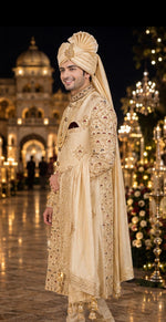 Shreemaan golden silk sherwani with hand jardozi embroidery all over to give the groom a very stylish look with silk safa & dupatta combined with Shewani mala
