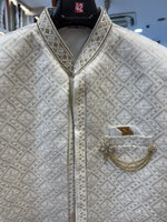 Shree Maan Hand made silk Sherwani for men with minute Hand Embroidery crafted all over specially on the collar and full front pant visible on the off white ivory color cloth .