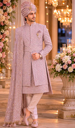 Rajwada rose gold color sherwani with dupatta , saafa , juti , sherwani mala & Kamarbanda to embrace the groom look in the most stylish way possible for your beautiful wedding ceremony. All over tone to tone beads handcrafted of same rose gold color .