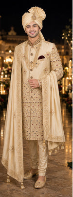 Shreemaan golden silk sherwani with hand jardozi embroidery all over to give the groom a very stylish look with silk safa & dupatta combined with Shewani mala