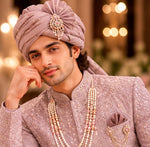 Rajwada rose gold color sherwani with dupatta , saafa , juti , sherwani mala & Kamarbanda to embrace the groom look in the most stylish way possible for your beautiful wedding ceremony. All over tone to tone beads handcrafted of same rose gold color .