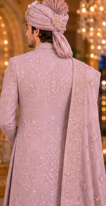 Rajwada rose gold color sherwani with dupatta , saafa , juti , sherwani mala & Kamarbanda to embrace the groom look in the most stylish way possible for your beautiful wedding ceremony. All over tone to tone beads handcrafted of same rose gold color .