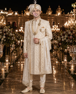 Shree Maan Hand made silk Sherwani for men with minute Hand Embroidery crafted all over specially on the collar and full front pant visible on the off white ivory color cloth .